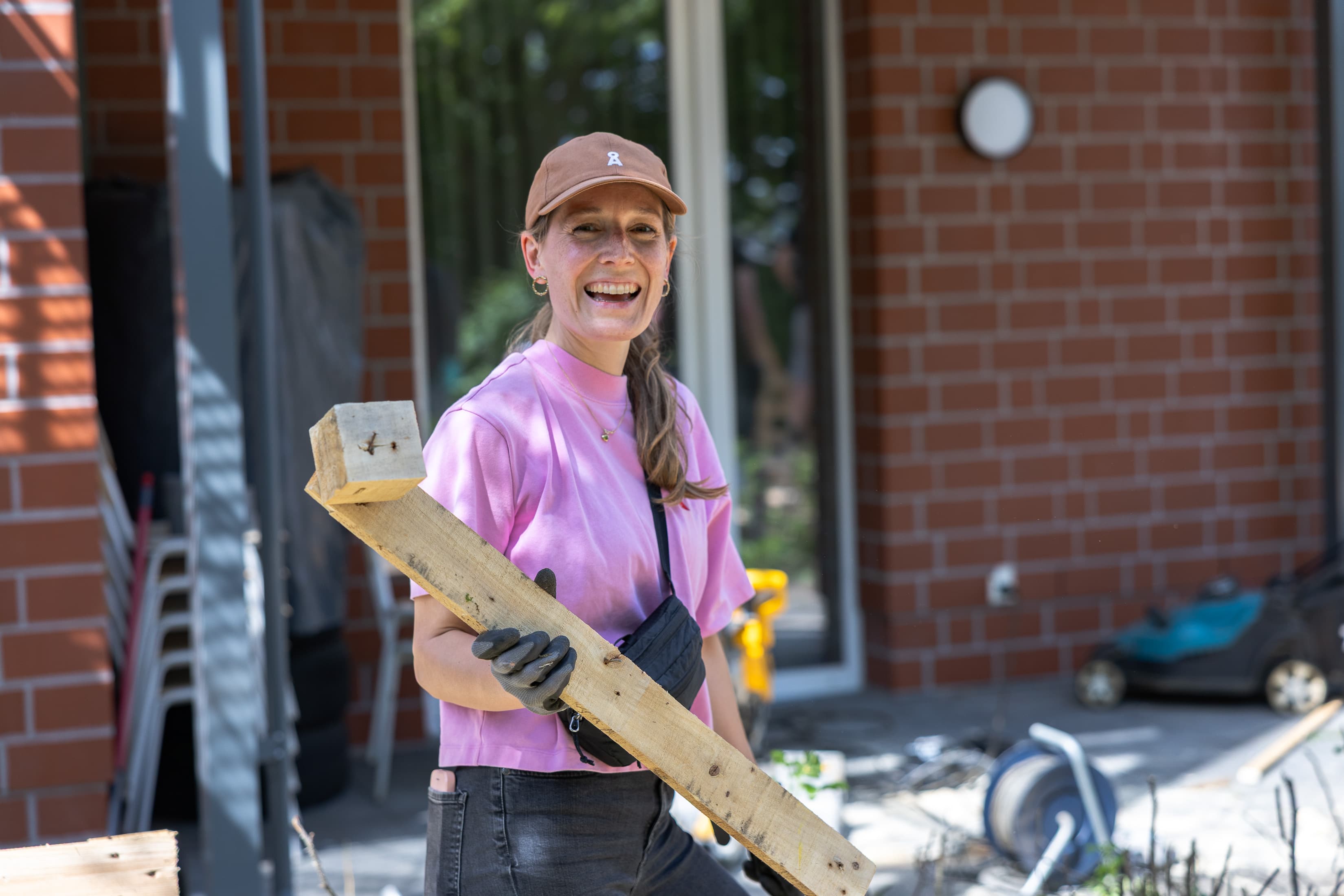 Nina Ruhnow, Abteilungsleiterin Nachhaltigkeit, bei einem Corporate Volunteering Einsatz um Gartenmöbel für eine Geflüchtetenunterkunft zu bauen.